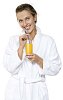 Woman in bathrobe sipping juice