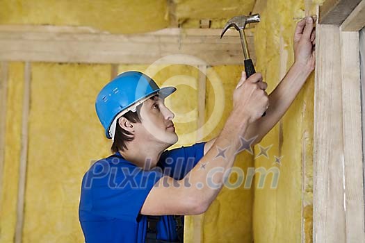 Male carpenter nailing Male carpenter nailing