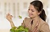 Woman eating a green salad