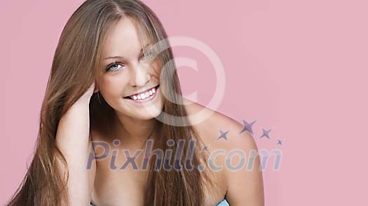 Woman smiling on a pink background Woman smiling on a pink background