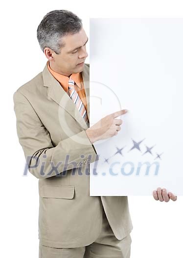 Businessman showing something on a blank poster Businessman showing something on a blank poster