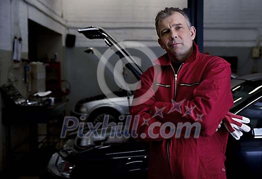 Male mechanic standing in the repair shop Male mechanic standing in the repair shop