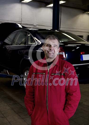 Man standing at the repair shop Man standing at the repair shop