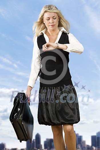 Businesswoman looking at her watch Businesswoman looking at her watch