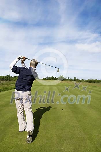 Male golfer at the golfcourse Male golfer at the golfcourse