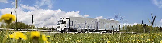 Truck on the road by the grass Truck on the road by the grass