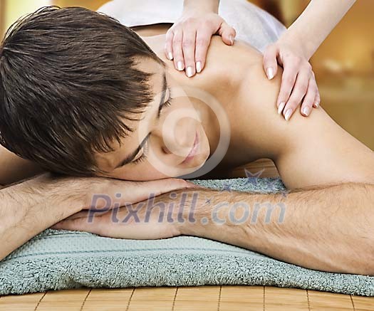Sporty male getting shoulder massage Sporty male getting shoulder massage