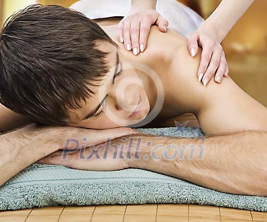 Sporty male getting shoulder massage