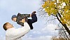 Father and son playing in autumn park