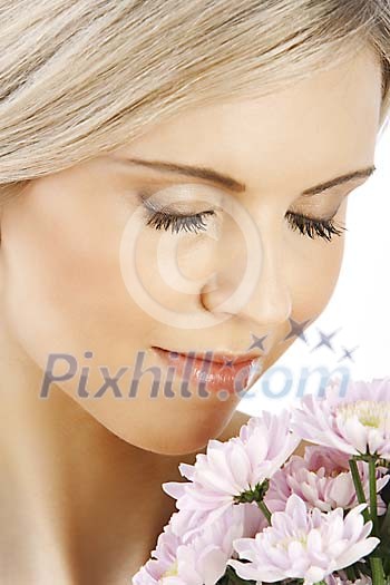 Beautiful girl smelling flowers