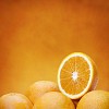 Group of fresh oranges on orange background