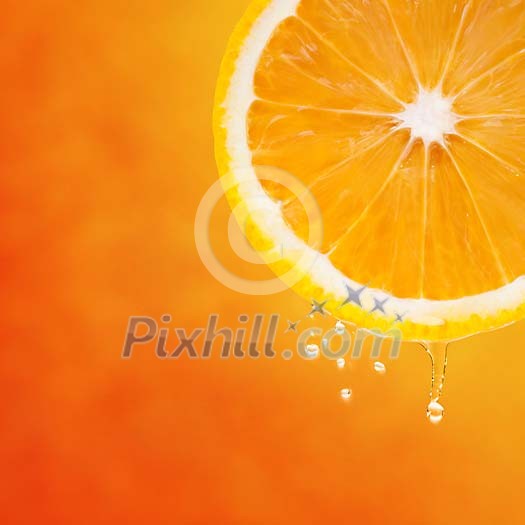 Fresh slice of orange with cool drops on orange background