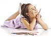 Young girl lying on floor with color pencils