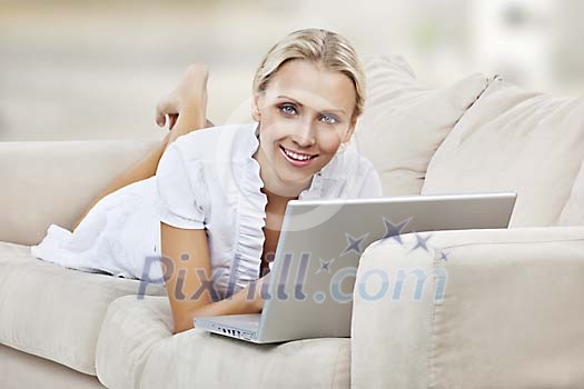 Woman on the couch with laptop Woman on the couch with laptop