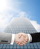 Handshake in front of a business building