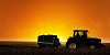 Tractor on the field in the evening darkness