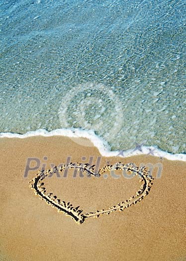Heart on the sand near water Heart on the sand near water