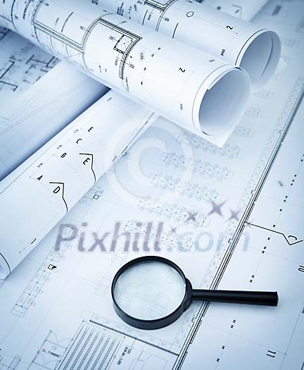 Magnifying glass on the blueprints Magnifying glass on the blueprints