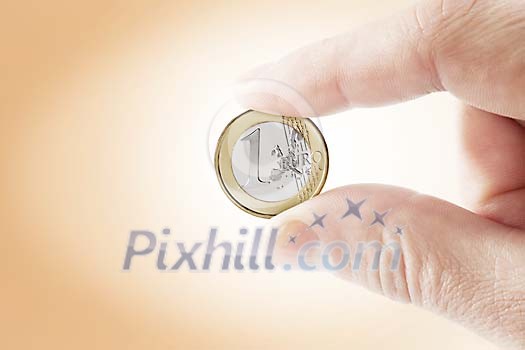 Hand holding a coin Hand holding a coin