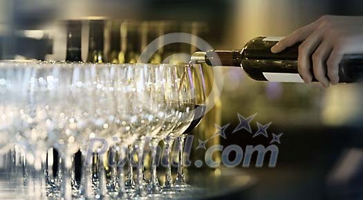 Wine glasses being filled Wine glasses being filled