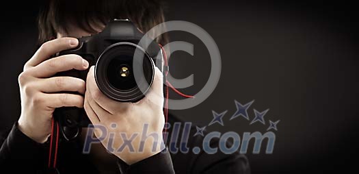 Man holding a photocamera and taking a picture Man holding a photocamera and taking a picture