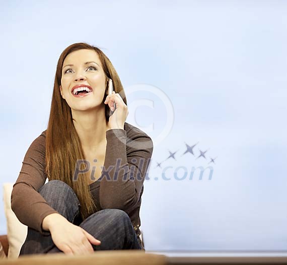Woman sitting and talking on the phone Woman sitting and talking on the phone