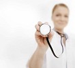 Female doctor holding the stetoscope close to the camera