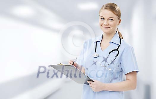 Female nurse writing down notes Female nurse writing down notes