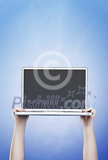 Hands holding laptop up in the air Hands holding laptop up in the air