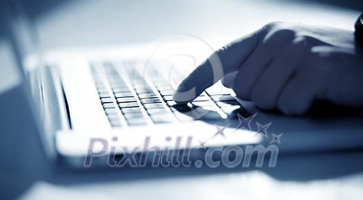 Finger pushing a button on keyboard Finger pushing a button on keyboard