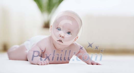 Baby on the floor looking at the camera Baby on the floor looking at the camera