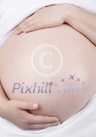 Pregnant stomach with female hand Pregnant stomach with female hand