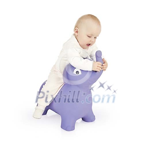 Baby girl sitting on a toy elephant Baby girl sitting on a toy elephant