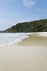 Empty beach with green hill on the background at Koh Samet, Thailand