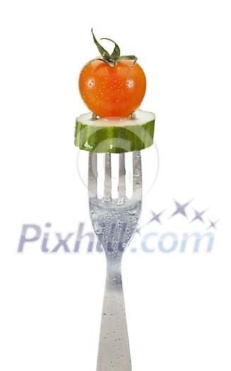 Clipped fork with a tomato and slice of cucumber Clipped fork with a tomato and slice of cucumber
