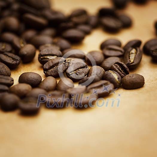 Closeup of a coffee beans on a brown paper Closeup of a coffee beans on a brown paper