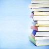 Pile of books on a light blue background