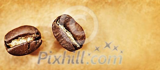 Background of two coffee beans on a brown paper Background of two coffee beans on a brown paper