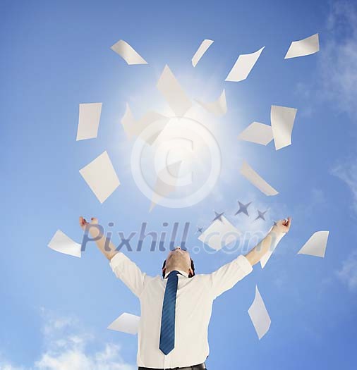 Man throwing a pile of documents up to the sunny sky Man throwing a pile of documents up to the sunny sky