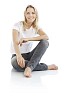 Relaxed woman sitting on floor, isolated on white