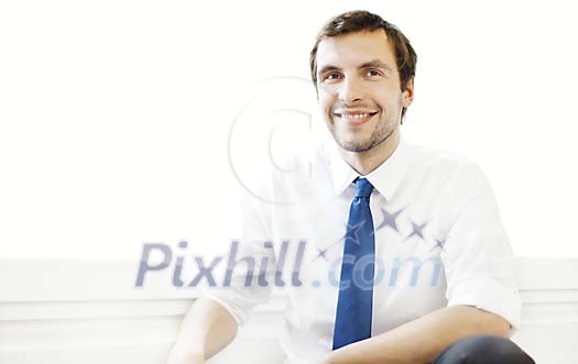 30 year old man in white shirt and blue tie smiling to camera