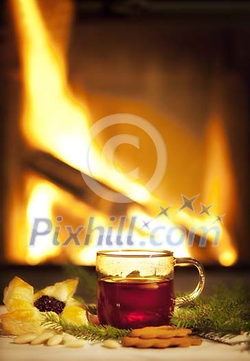 Mulled wine and christmas pastry by the fireplace Mulled wine and christmas pastry by the fireplace