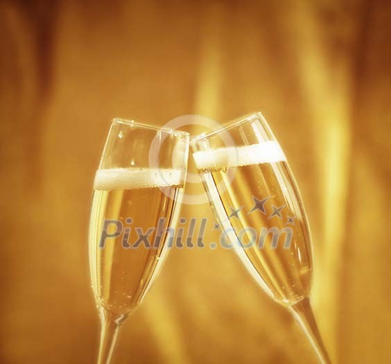 Two champagne glasses toasting