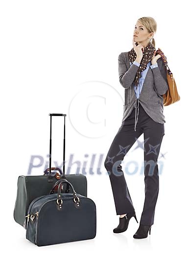 Clipped businesswoman standing next to her luggage Clipped businesswoman standing next to her luggage