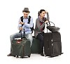 Clipped couple sitting on the luggage and looking frustrated