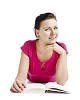 Clipped woman on the floor with a book looking straight at the camera