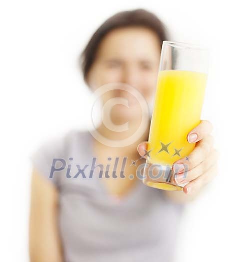 Defocused woman offering glass of juice Defocused woman offering glass of juice