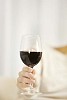 Hand holding a glass of red wine