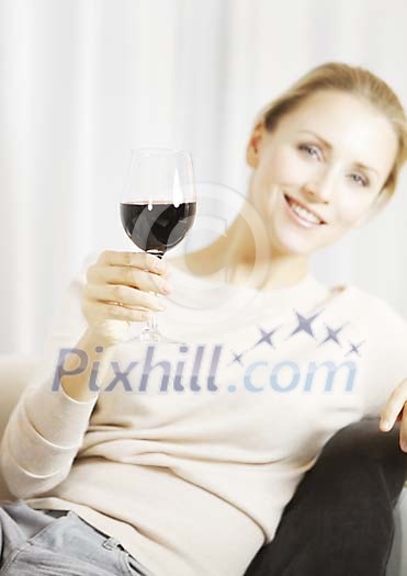 Woman sitting with a glass of red wine Woman sitting with a glass of red wine