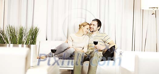 Couple enjoying wine on the sofa Couple enjoying wine on the sofa
